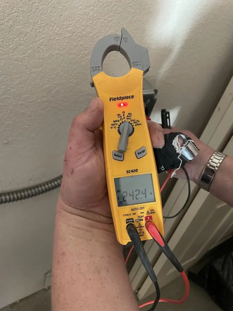 Voltage testing with clamp meter during Recessed Lighting Installation in St. Charles